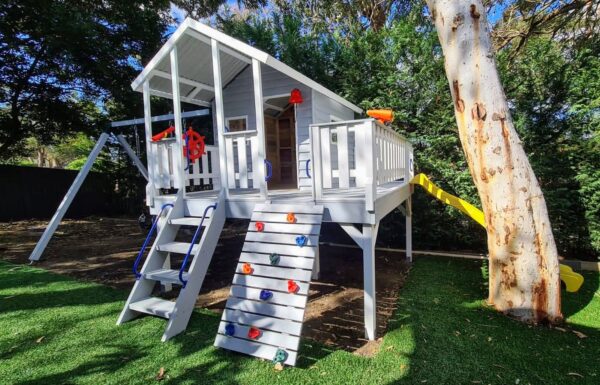 Elavated cubby house with large verandah swings and slide