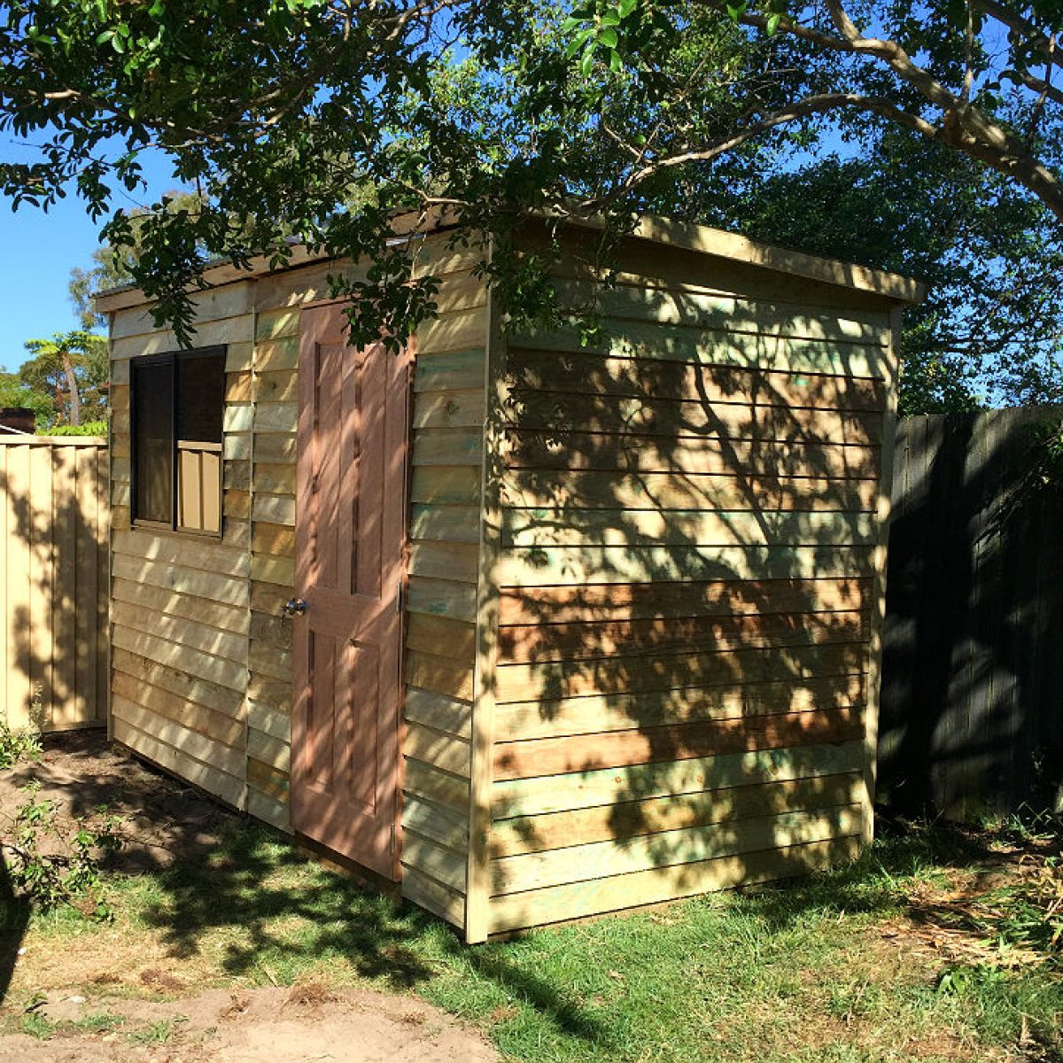 secure wooden garden shed with windows and slanted colorbond roof